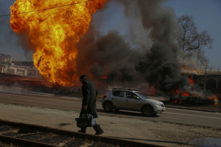 A man walks past a fire after Russian shelling in Kharkiv, Ukraine, March 25, 2022.
