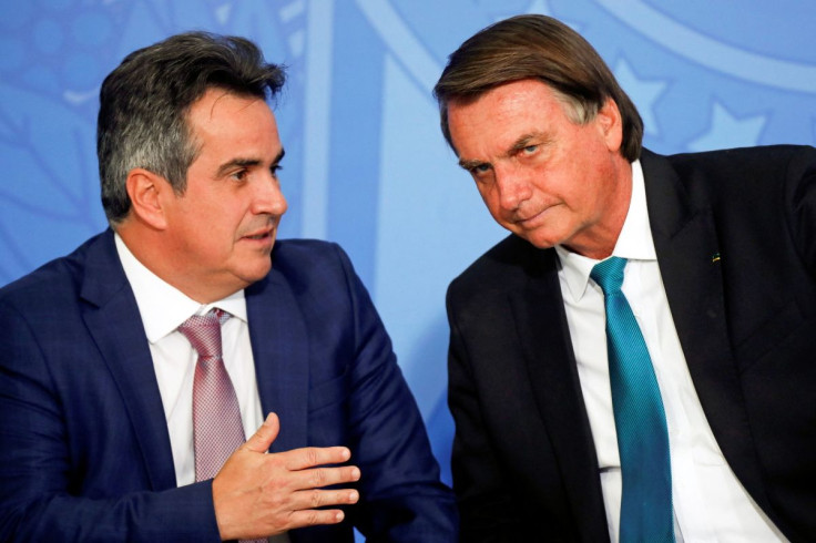 Brazil's President Jair Bolsonaro talks with Chief of Staff of the Presidency Ciro Nogueira during a launching ceremony of the new securitization framework and strengthening of guarantees for Agro business in Brasilia, Brazil March 15, 2022.Picture taken