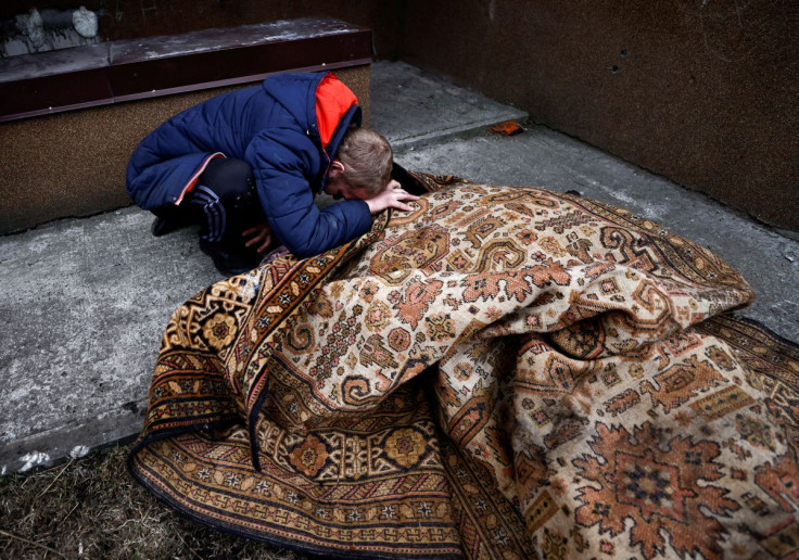 Serhii Lahovskyi, 26, mourns by the body of his friend Ihor Lytvynenko, who according to residents was killed by Russian Soldiers, after they found him beside a building's basement, amid Russia's invasion of Ukraine, in Bucha, Ukraine April 5, 2022. 