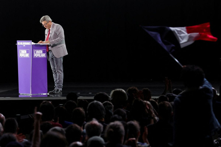A person in the audience waves a French flag during a political campaign rally held by Jean-Luc Melenchon, leader of the far-left opposition party La France Insoumise (France Unbowed - LFI) and L'Union populaire (popular union) candidate in the 2022 Frenc