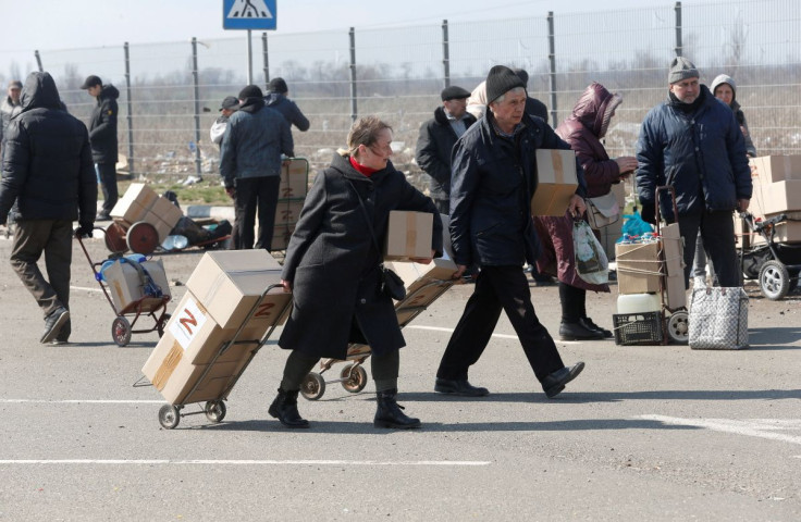 People transport boxes with humanitarian aid in the course of Ukraine-Russia conflict in the southern port city of Mariupol, Ukraine April 5, 2022. 
