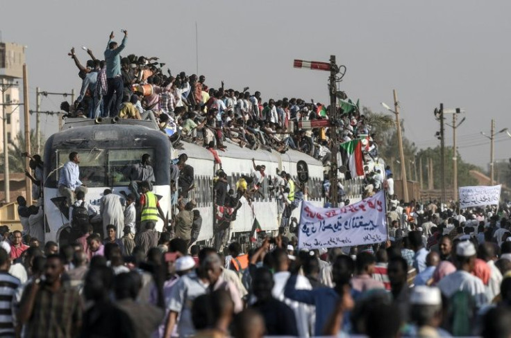 In this photo taken in April 2019, protesters from the city of Atbara cheer upon arriving at the Bahari station in Sudan's capital Khartoum -- Sudanese protesters are gearing up for mass anti-coup rallies on April 6