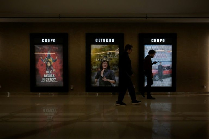 Bye bye Hollywood: Men walk past film posters in a hallway of the giant Oktyabr cinema in Moscow