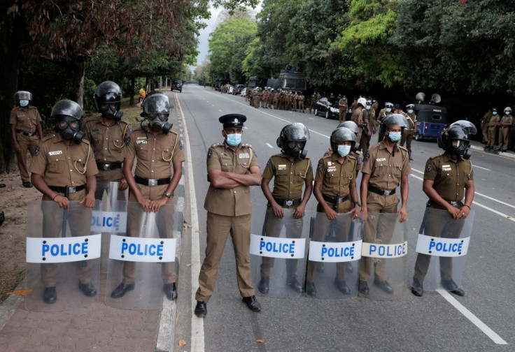 Sri Lanka police officers stand guard on a road leading to the parliament building, after the government of President Gotabaya Rajapaksa lost its majority, amid the country's economic crisis, in Colombo, Sri Lanka, April 5, 2022.