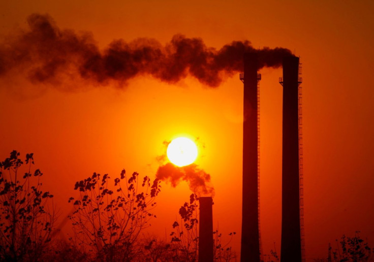Smoke spews from chimneys of an oil refinery in Nanjing, east China's Jiangsu province, December 28, 2006. 