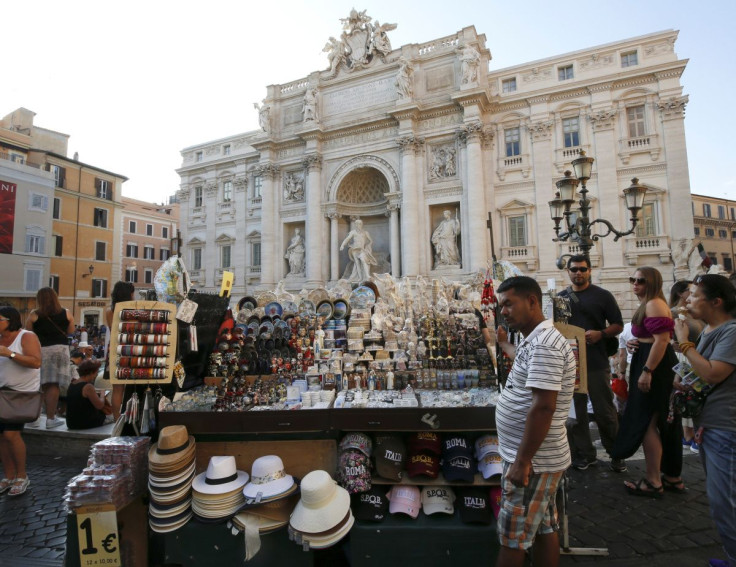 A vendor sells souvenirs at Trevi Fountain in Rome, Italy, August 29, 2019.