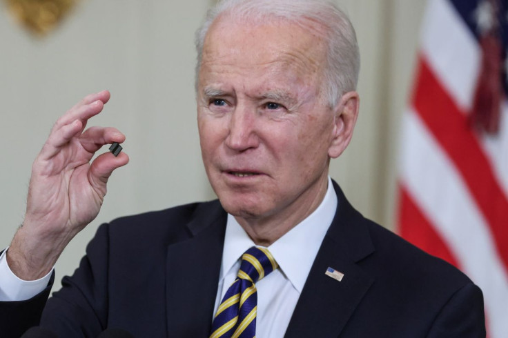 U.S. President Joe Biden delivers holds a semiconductor chip as he speaks  prior to signing an executive order, aimed at addressing a global semiconductor chip shortage, in the State Dining Room at the White House in Washington, U.S., February 24, 2021. 