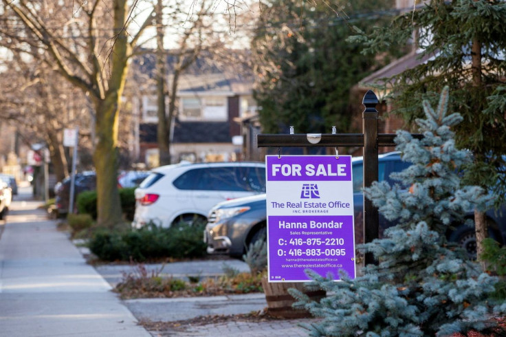 A for sale sign is displayed outside a home in Toronto, Ontario in Toronto, Ontario, Canada December 13, 2021.  