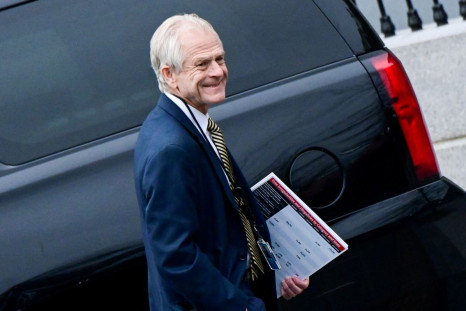 Former White House advisor Peter Navarro leaves the West Wing carrying a poster board displaying claims of voting irregularity at the White House in Washington, U.S., January 15, 2021. 