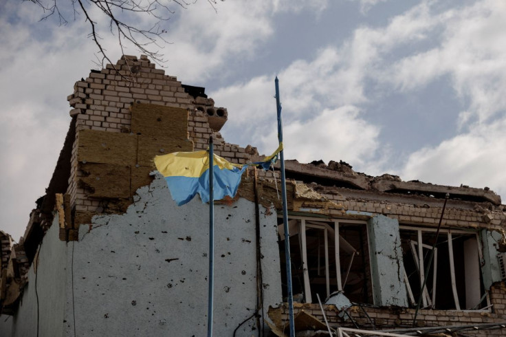 The Ukrainian flag flies outside the town administration building that was damaged during heavy shelling in the town of Derhachi outside Kharkiv, as Russia's attack on Ukraine continues, in Ukraine, April 6, 2022.  