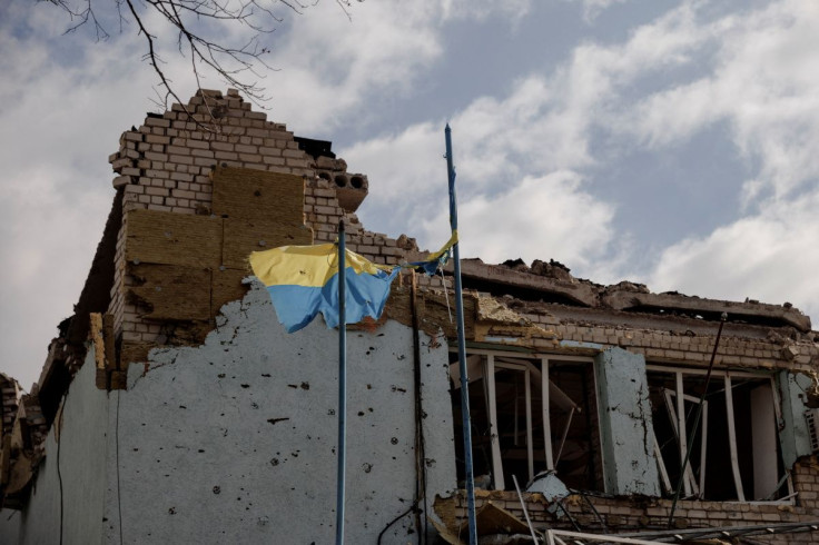 The Ukrainian flag flies outside the town administration building that was damaged during heavy shelling in the town of Derhachi outside Kharkiv, as Russia's attack on Ukraine continues, in Ukraine, April 6, 2022.