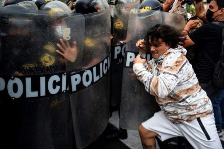 People clash with riot police during a protest against the government of Peru's President Pedro Castillo, in Lima on April 5, 2022