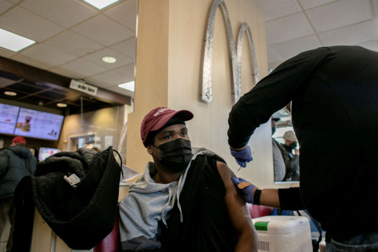 A man receives a booster shot for the coronavirus disease (COVID-19) at a McDonald's, as the Omicron coronavirus variant spreads through the country, in Chicago, Illinois, U.S., December 21, 2021. 