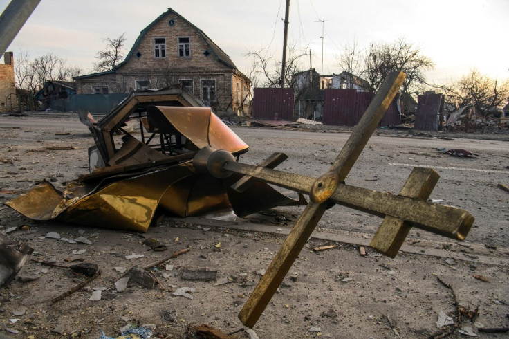 A cross and a destroyed dome of a local church damaged by shelling are seen on a road, as Russia's attack on Ukraine continues, in the settlement of Hostomel, outside Kyiv, Ukraine April 6, 2022.  