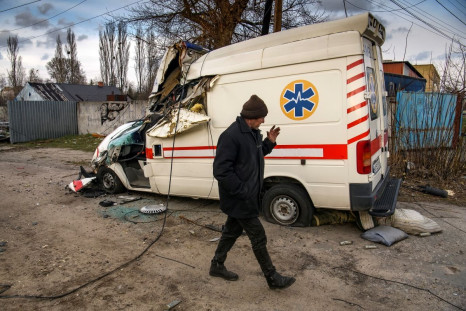 A local man walks past a damaged ambulance, as Russia's attack on Ukraine continues, in the settlement of Hostomel, outside Kyiv, Ukraine April 6, 2022.  