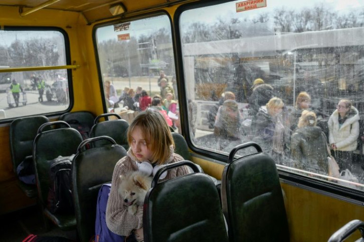 A young evacuee with her dog arrives in Zaporizhzhia on April 6, 2022