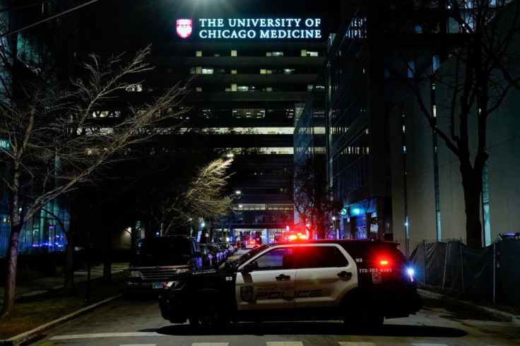 A law enforcement vehicle blocks the road after gunshot victims were dropped off in front of the University of Chicago Medicine, which operates the only Level 1 Adult Trauma Center on Chicago's South Side, during the deadliest year for homicides since 199