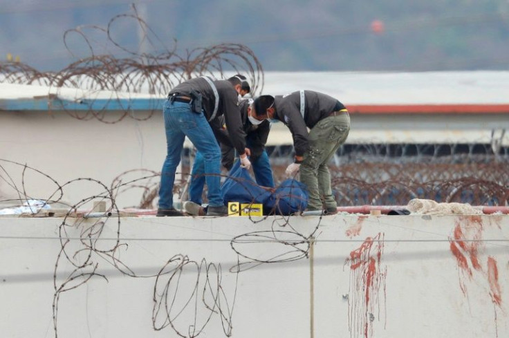 Ecuadorian police remove a dead inmate's body from the roof of the Guayas 1 prison in Guayaquil, Ecuador, on November 13, 2021