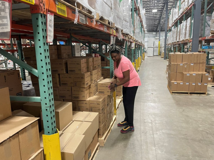 Sheila Ikenye picks boxes for a shipment at Kem Krest's warehouse in Elkhart, Indiana, U.S. March 24, 2022. 