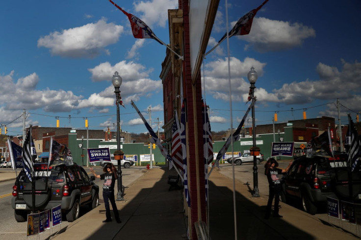 A supporter of U.S. President Donald Trump holds a campaign sign outside the Republican headquarters in Union City, Pennsylvania, U.S., October 23, 2020.  