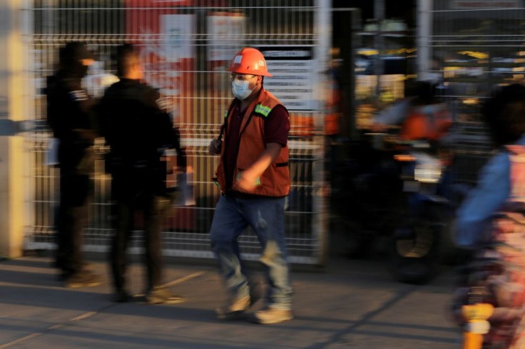 An employee leaves the General Motors' pickup truck plant as workers vote to elect a new union under a labor reform that underpins a new trade deal with Canada and the United States, in Silao, Mexico February 1, 2022. 