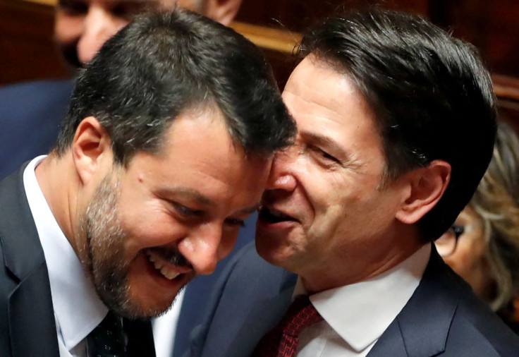 Italian Prime Minister Giuseppe Conte speaks with Italian Deputy PM Matteo Salvini before addressing the upper house of parliament over the ongoing government crisis, in Rome, Italy August 20, 2019. 