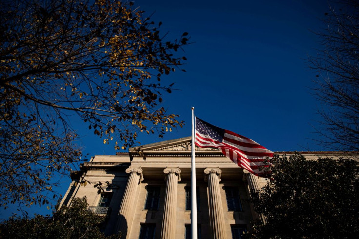 An American flag waves outside the U.S. Department of Justice Building in Washington, U.S., December 15, 2020. 
