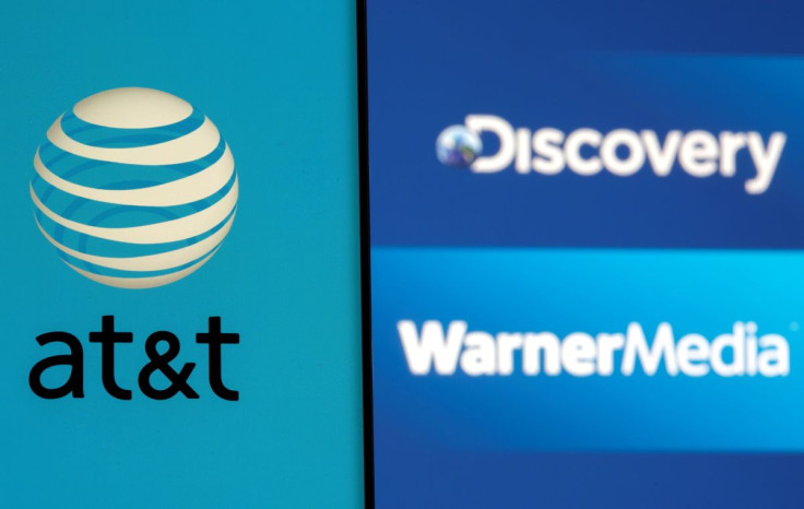 AT&T logo is seen on a smartphone in front of displayed Discovery and Warner Media logos in this illustration taken May 17, 2021. 