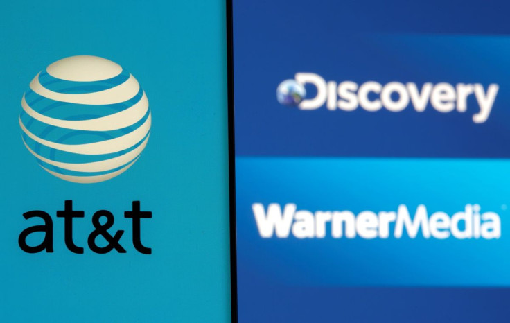 AT&T logo is seen on a smartphone in front of displayed Discovery and Warner Media logos in this illustration taken May 17, 2021.