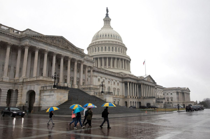 Visitors walk with umbrellas during a storm on Capitol Hill in Washington, U.S., March 17, 2022.