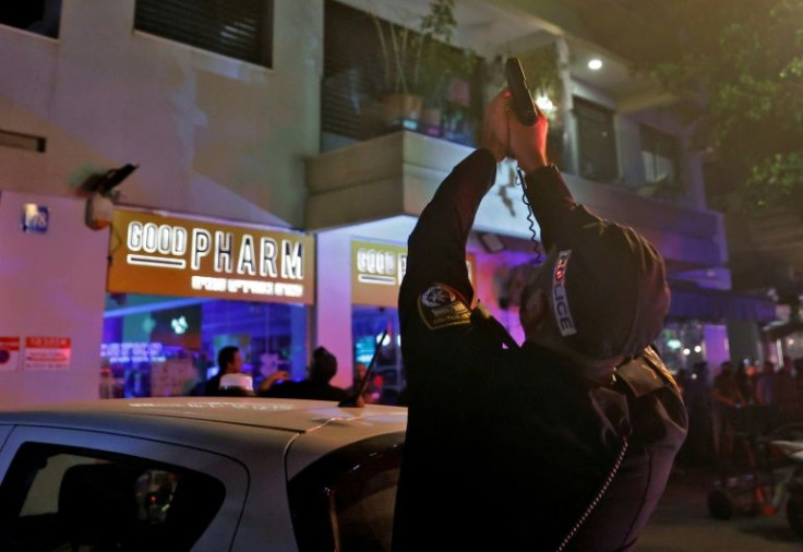 A policeman takes aim in Tel Aviv after the deadly attack