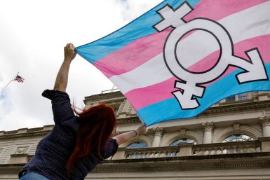 A person holds up a flag during rally to protest the Trump administration's reported transgender proposal to narrow the definition of gender to male or female at birth, at City Hall in New York City, U.S., October 24, 2018. 