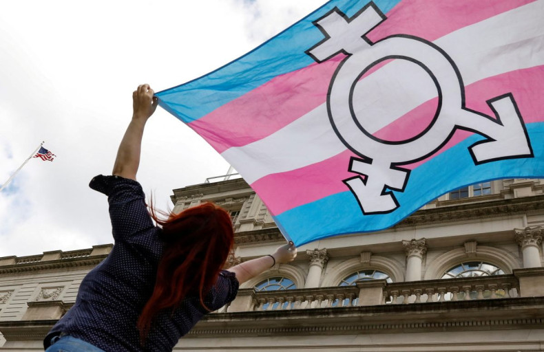 A person holds up a flag during rally to protest the Trump administration's reported transgender proposal to narrow the definition of gender to male or female at birth, at City Hall in New York City, U.S., October 24, 2018. 