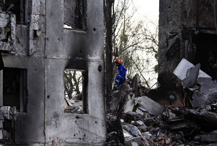 A rescuer sits in a rubble of a building that was destroyed by Russian shelling, amid Russia's invasion of Ukraine, in Borodyanka, Kyiv region, Ukraine April 7, 2022. 