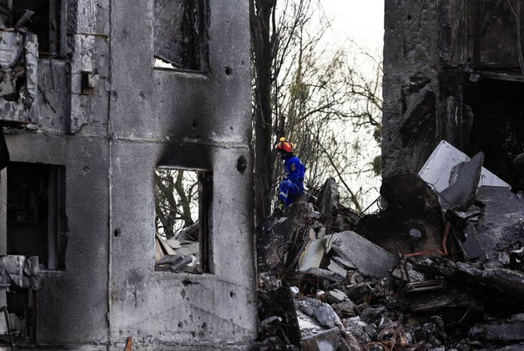 A rescuer sits in a rubble of a building that was destroyed by Russian shelling, amid Russia's invasion of Ukraine, in Borodyanka, Kyiv region, Ukraine April 7, 2022.