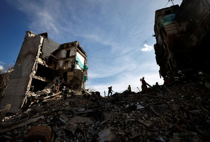 Rescuers work among remains of residential building destroyed by Russian shelling, amid Russia's invasion of Ukraine, in Borodyanka, Kyiv region, Ukraine April 7, 2022. 