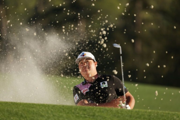 First round leader: Im Sung-jae of South Korea plays out of a bunker at 18 on the way to the first-round lead in the 86th Masters at Augusta National