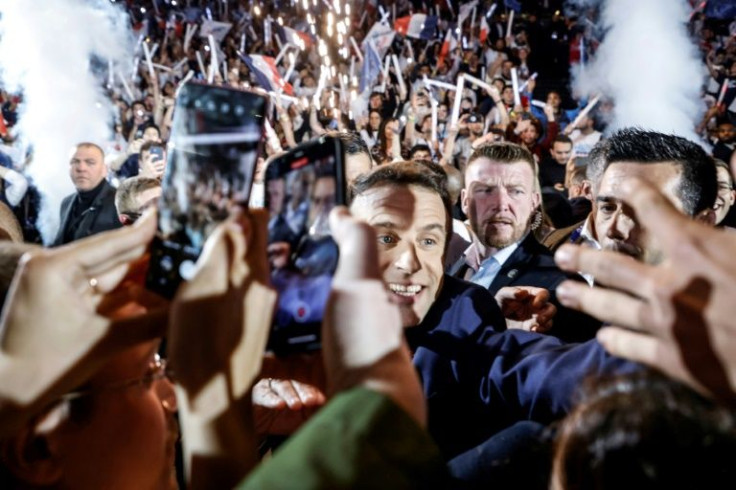 Struggling to get through: French President Emmanuel Macron at an election rally near Paris