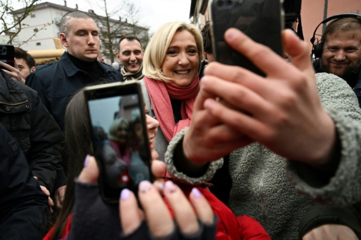 French far-right leader Marine Le Pen (C) has spent months pressing the flesh