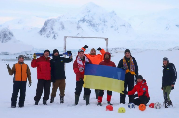 Ukranian scientists at the Vernadsky Antarctic base hold a national flag