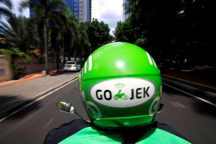 A Go-Jek driver rides a motorcycle on a street in Jakarta, Indonesia, Dec, 15, 2017.
