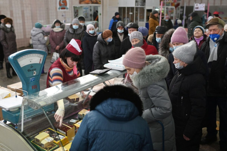 Customers line up next to a counter at a market in Omsk, Russia February 18, 2022.