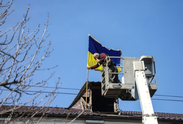 A local official raised the Ukrainian flag above the municipal building for the first time since the occupation by Moscow's forces