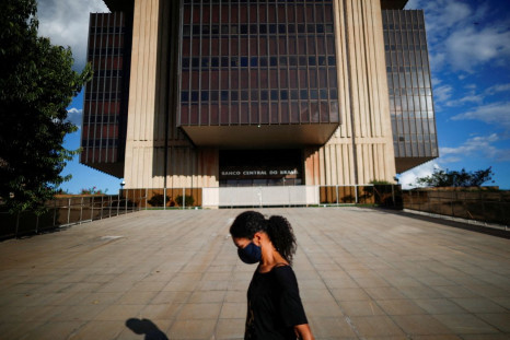 A woman walks in front the Central Bank headquarters building in Brasilia, Brazil March 22, 2022. 