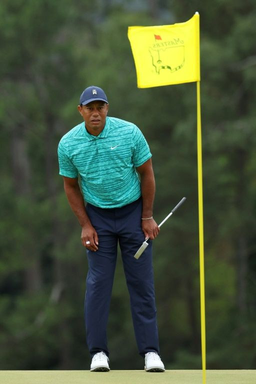 Tiger Woods lines up a putt on the 18th green during Friday's second round of the Masters