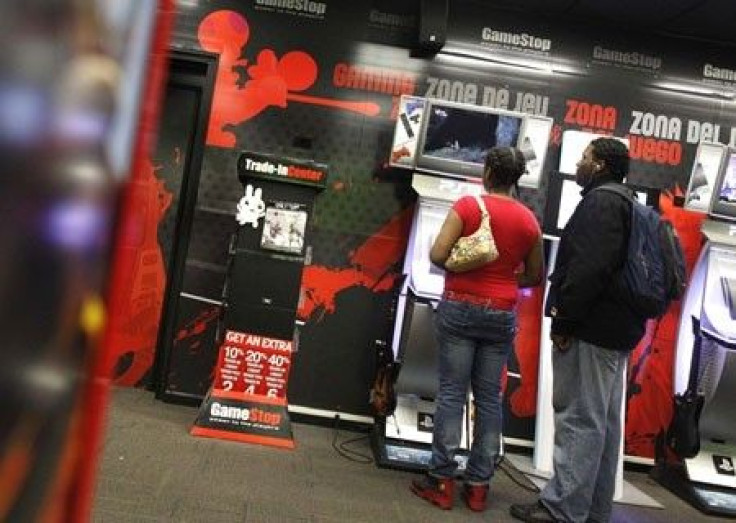 People play video games inside a GameStop retail store in New York March 18, 2010