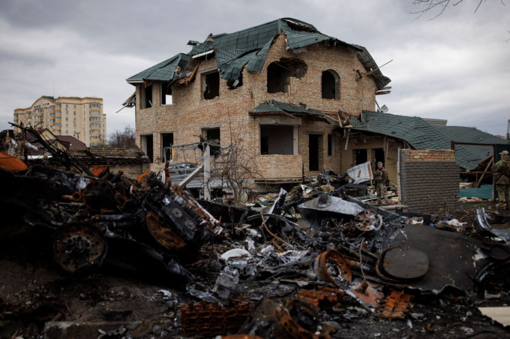 Ukrainian soldiers inspect a destroyed house, amid Russia's invasion of Ukraine, in Bucha, in Kyiv region, Ukraine, April 6, 2022. 