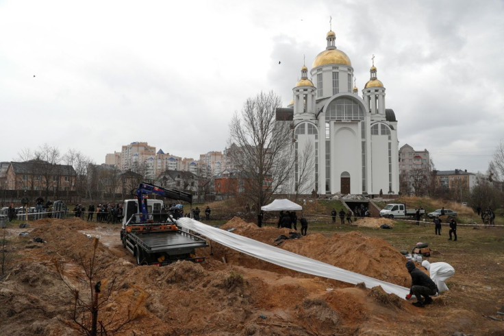 Forensic technicians exhume the bodies of civilians who Ukrainian officials say were killed during Russia's invasion and then buried in a mass grave in the town of Bucha, outside Kyiv, Ukraine April 8, 2022.  