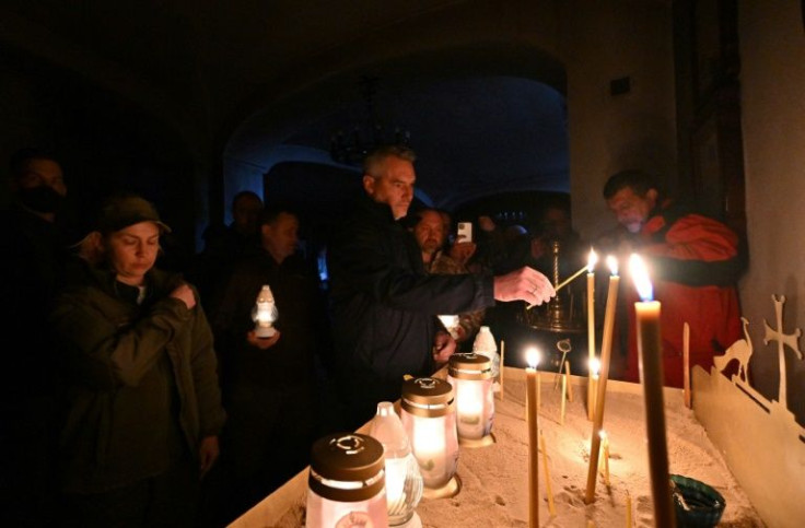 Austrian Chancellor Karl Nehammer lit candles at a church after visiting mass graves in Bucha