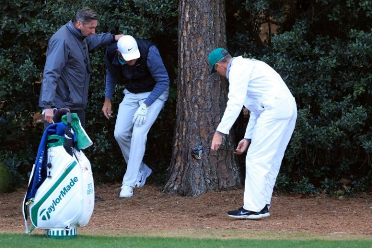 American Scottie Scheffler prepares to take a drop on the 18th hole on the way to the 54-hole lead at the Masters at Augusta National